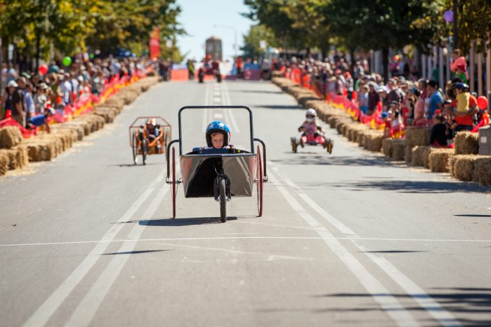 Boy racing billy cart down main street Australian Billy Cart Championships at corowa